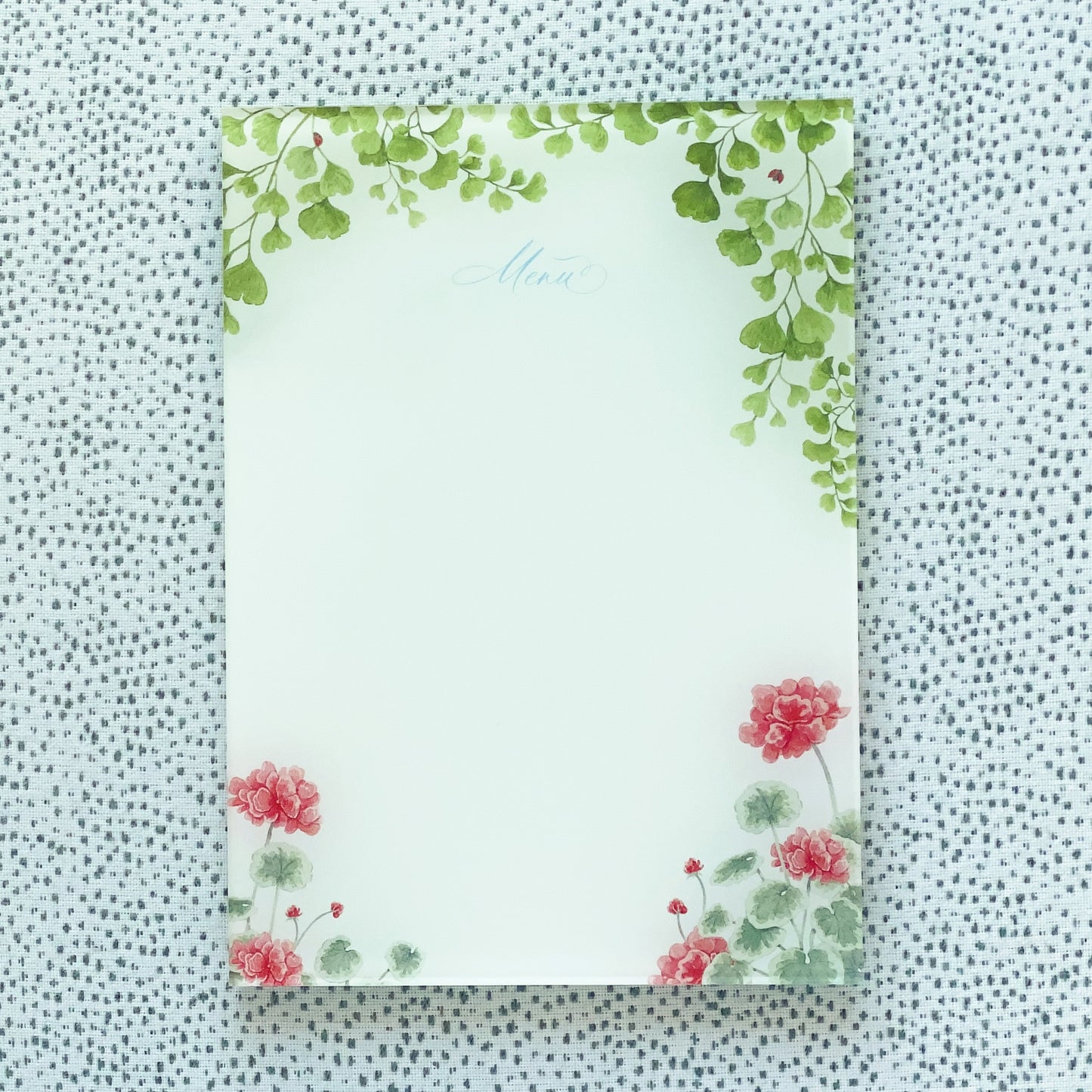Acrylic menu with maidenhair fern and red geranium watercolor artwork as a frame.