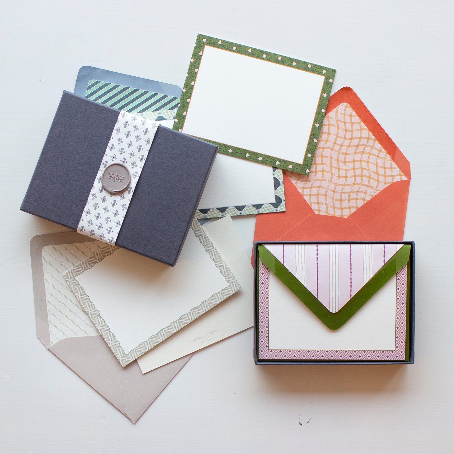 An overhead photo of all Rebecca Rose at Home pattern play stationery cards and envelopes, displaying gift box presentation.