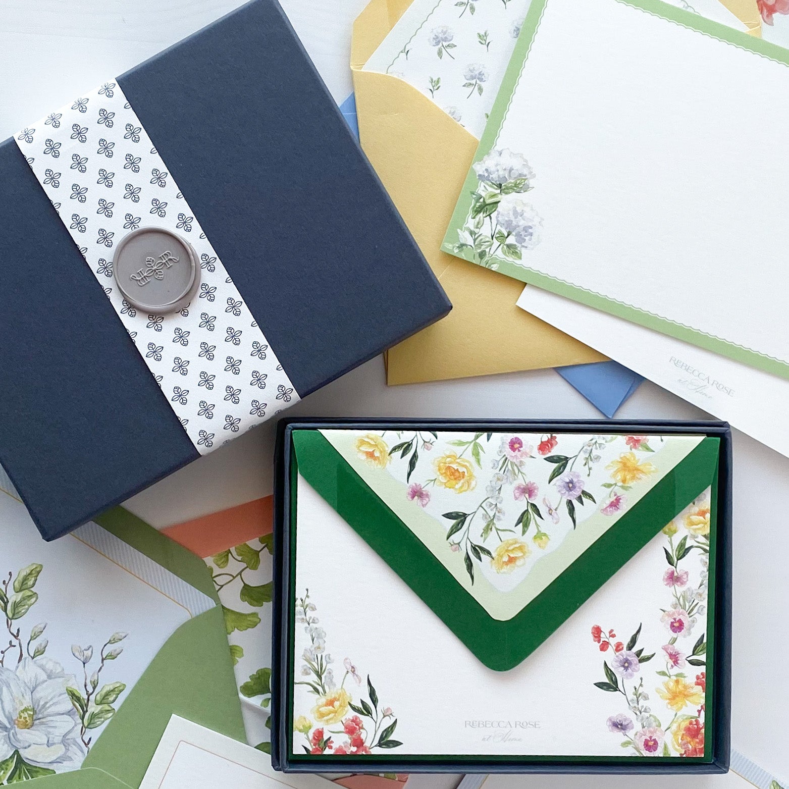 Stationary boxed set in navy blue box with patterned belly band and gray wax seal